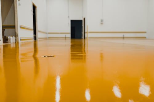 High-gloss seamless epoxy floor coating in a large commercial interior