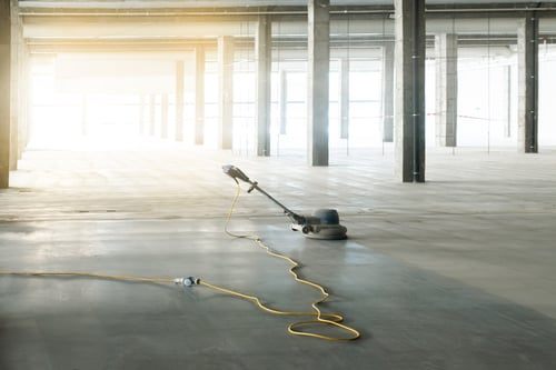 Polished concrete floor being finished inside a large commercial interior